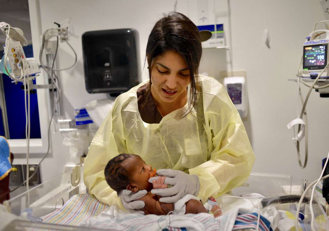 Woman providing Occupational therapy to a young baby