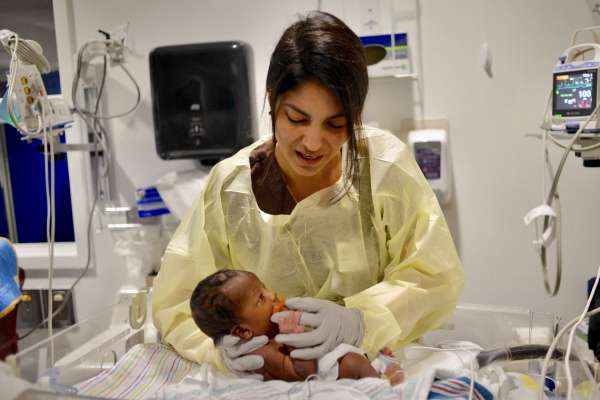 Woman providing Occupational therapy to a young baby
